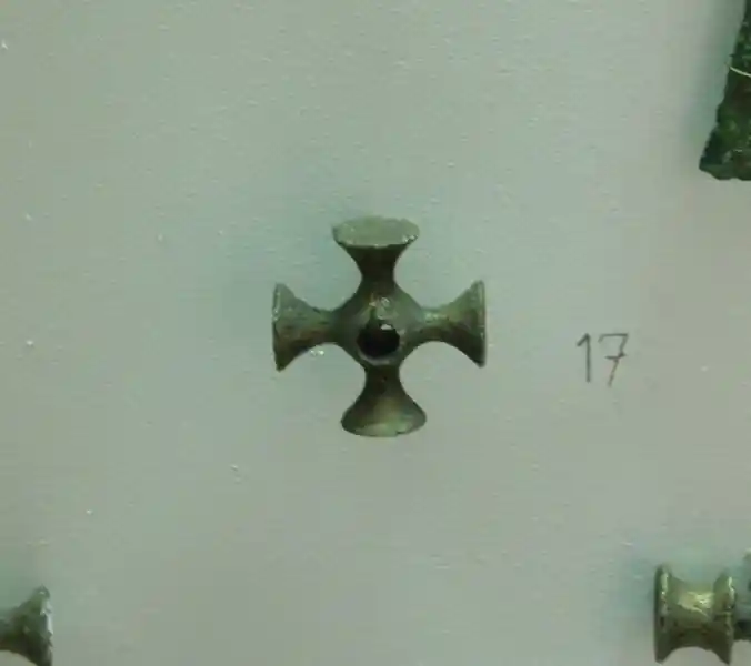 A metal cross without frame and with a circle in the center